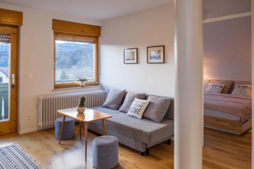 a living room with a couch and a bed at HOMe apartments & Yoga studio in Bled-Rečica