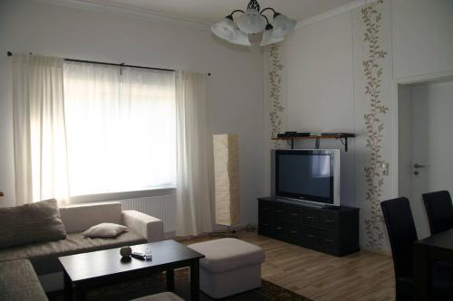 a living room with a couch and a tv at FeWo Vahls Mika in Elmenhorst