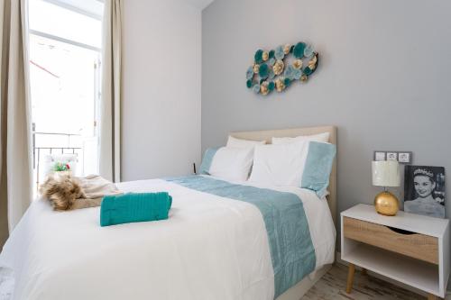 a bedroom with two beds with a dog laying on the bed at Mi Bohemia Caleta in Cádiz