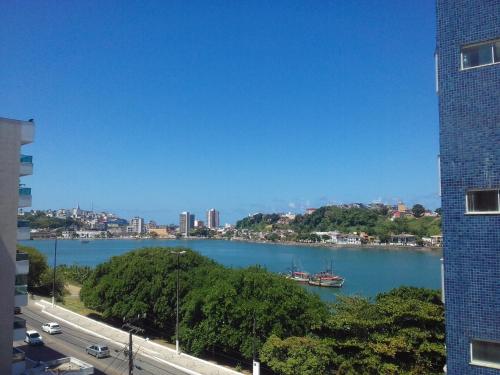 a view of a river with a city in the background at Privileg in Ilhéus