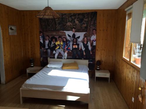 a bedroom with a bed with a group of people on the wall at chez steph&aurore in Lacanau
