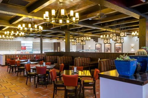 a dining room with tables and chairs and chandeliers at The Ranch At Death Valley in Death Valley