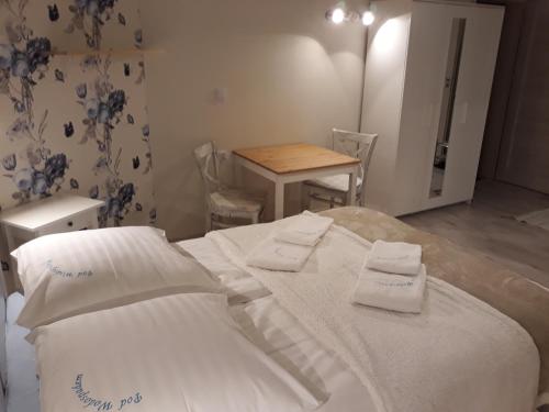 a bedroom with a bed and a table with chairs at Pod Wodospadem in Szczyrk