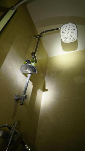 a bathroom with a shower with a light on the wall at Hostel near ski lift in Gudauri