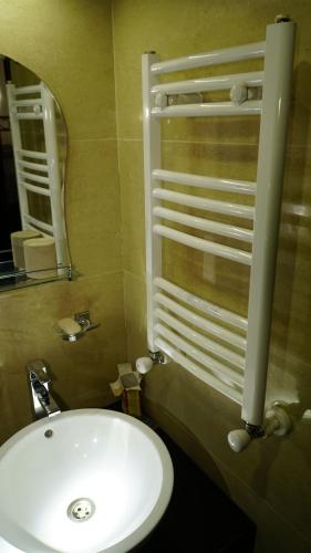 a bathroom with a white sink and a mirror at Hostel near ski lift in Gudauri