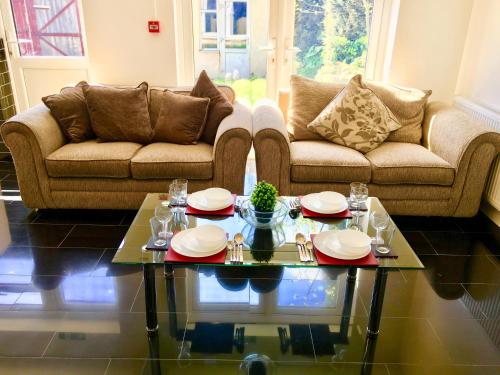 a living room with a couch and a table at London 2 Bedroom Apartment, Kitchen, Reception and Private Garden in London