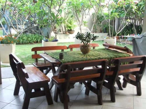 a wooden table with chairs and a vase on it at Bella Vista B @ B in North Haven