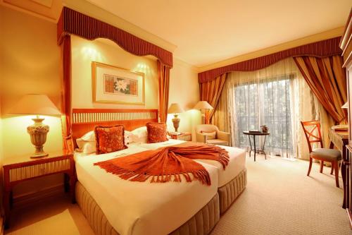 a hotel room with a large bed in a room at Peermont D'oreale Grande at Emperors Palace in Kempton Park