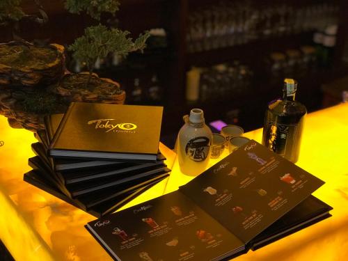 a table topped with brown boxes and bottles of wine at Flower Hotel Ulaanbaatar in Ulaanbaatar