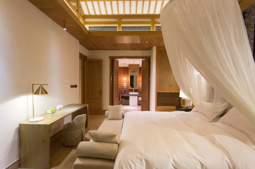 a bedroom with a bed with a mosquito net at Evergreen Retreat-walk to National Forest Park, free pick up service in Zhangjiajie