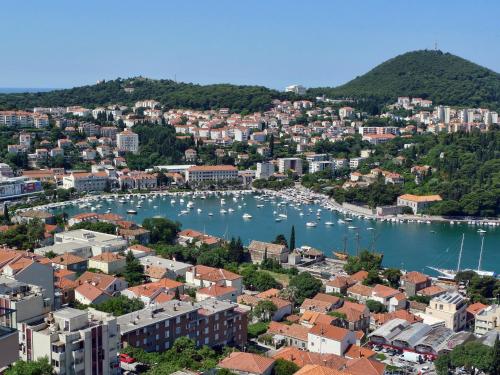 an aerial view of a city with boats in a harbor at Hotel Adria in Dubrovnik