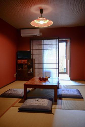 a living room with a table and a window at Nishioji KADO 西大路 角 わんちゃんと泊まれるお宿 in Kyoto