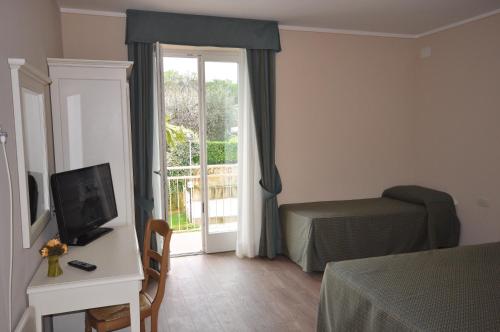 a room with a bedroom with a bed and a window at Hotel Panoramica in Salò