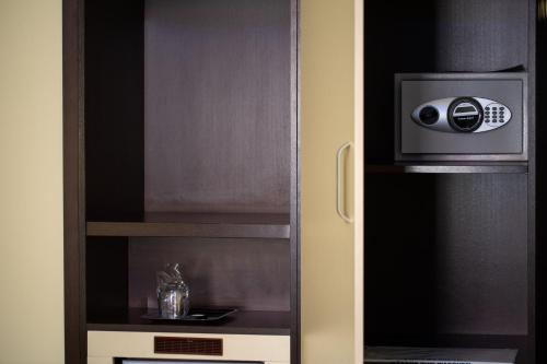 a cupboard with a speaker in it at Boutique Hotel Golden Star in Tuzla