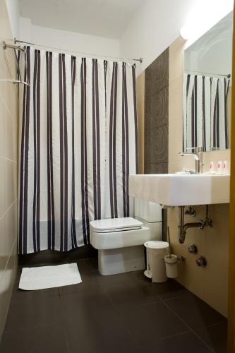 a bathroom with a sink and a toilet and a shower at Olympion in Athens