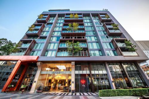 a tall building with a lot of windows at Civic Horizon Hotel & Residence in Bangkok