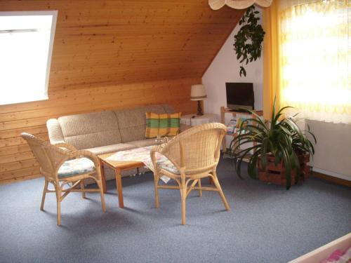 a living room with a couch and two chairs and a table at Steffens in Soltau