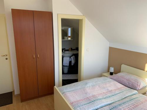 a small bedroom with a bed and a bathroom at Vinarija Zlatar in Zlatar