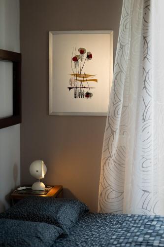 a bedroom with a bed with a white curtain at MaMà Suite in Lecce