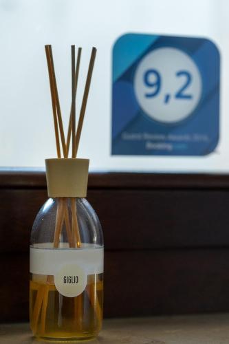 a bottle of oil with sticks in it on a table at MaMà Suite in Lecce