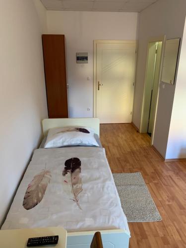 a bedroom with a bed with leaves on it at Vinarija Zlatar in Zlatar