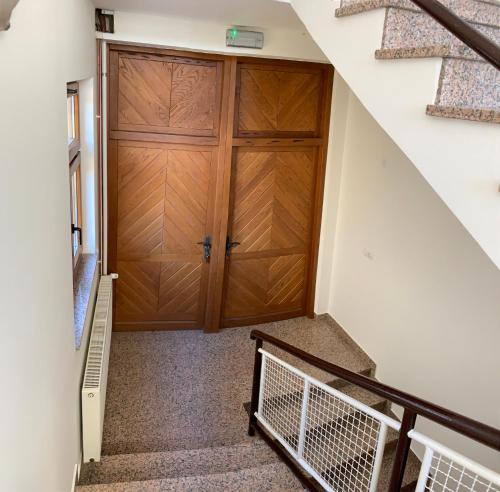 a staircase leading up to a wooden door in a house at Vinarija Zlatar in Zlatar