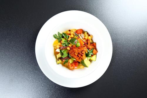 a white plate of food on a table at Active Hotel in Wrocław