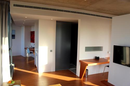 a living room with a door leading into a room at Bossa Nova Beirut Hotel in Beirut