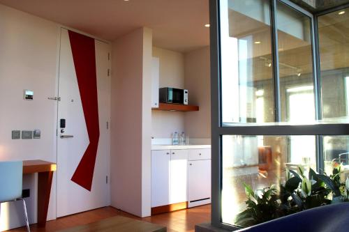 a kitchen with a red flag on the wall at Bossa Nova Beirut Hotel in Beirut