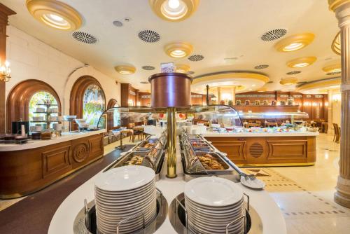 a restaurant with a buffet with plates on a table at Wyndham Istanbul Old City in Istanbul