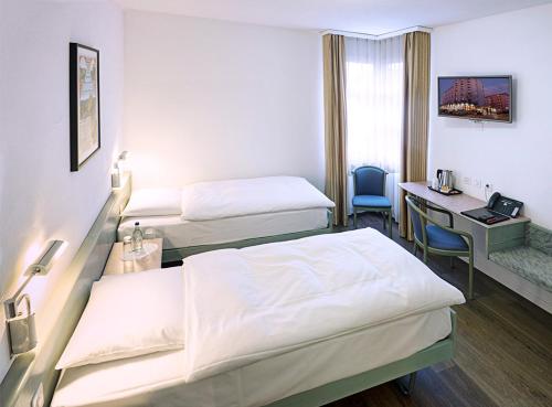 En eller flere senger på et rom på Sommerau-Ticino Swiss Quality Hotel