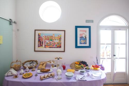 een tafel met een paars tafelkleed met voedsel erop bij Agriturismo Villa Lupara in Salerno