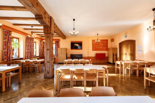 a restaurant with tables and chairs in a room at Jugendherberge Regensburg in Regensburg