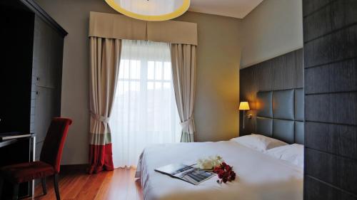 Postel nebo postele na pokoji v ubytování Hotel Porta Felice & Spa