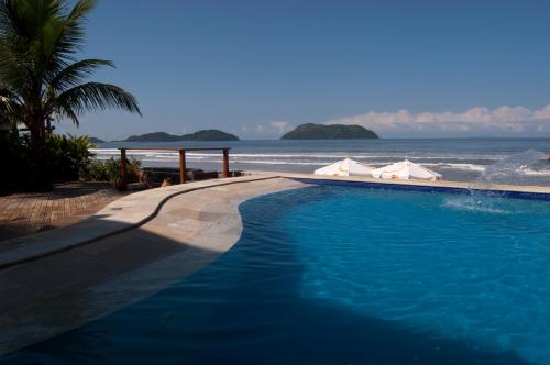 a swimming pool with a view of the ocean at Juquehy La Plage Hotel in Juquei