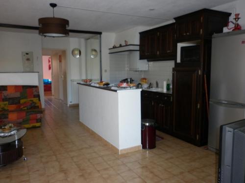 a kitchen with a white counter and a refrigerator at Agréable F3 sur Carnon-plage à 10 mn de Montpellier in Carnon-Plage