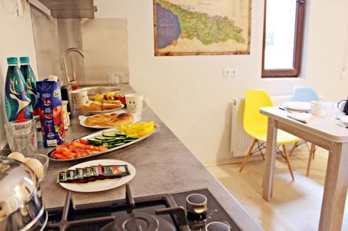 a kitchen with a counter top with food on it at Maria's homestay in Tbilisi City