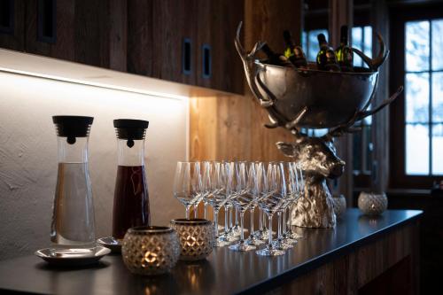 a table with wine glasses and a basket on it at Sunstar Hotel Klosters in Klosters
