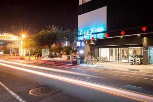 a city street at night with streaks of lights at D D Hotel in Tainan