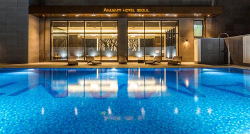 une piscine avec des chaises en face d'un bâtiment dans l'établissement Amanti Hotel Seoul, à Séoul