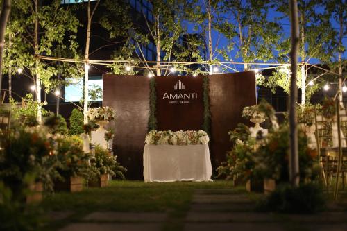 a sign for an event with a table with flowers at Amanti Hotel Seoul Hongdae in Seoul