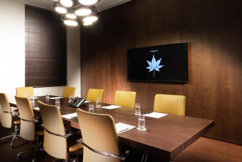 a conference room with a large wooden table and yellow chairs at Amanti Hotel Seoul Hongdae in Seoul