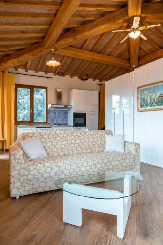 a living room with a couch and a table at Villa La Malva in Poggio alla Malva
