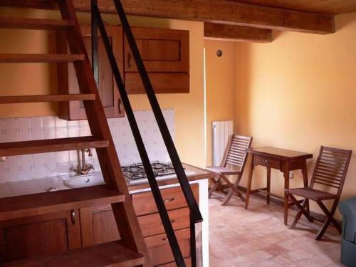 a kitchen with a staircase and a table and chairs at Regio Tratturo in Caporciano