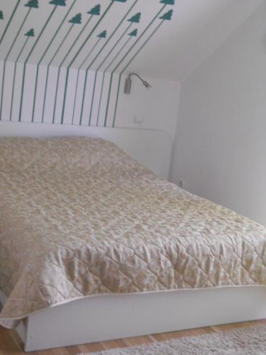 a bedroom with a bed with a white bed frame at Casa Preto E Branco in Moieciu de Jos