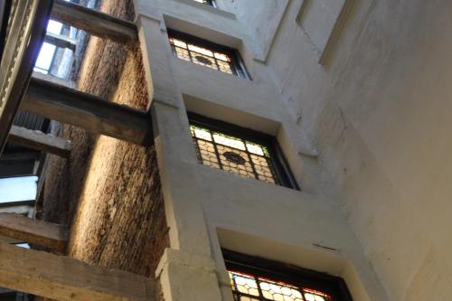 a staircase in a building with stained glass windows at Hotel Tayko Bilbao in Bilbao