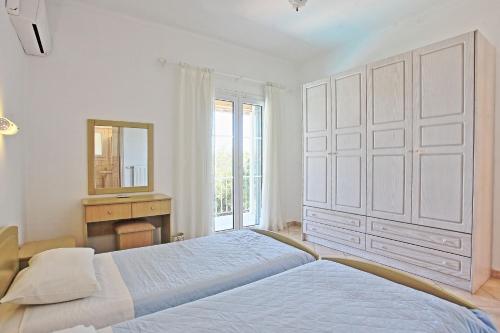 Ένα ή περισσότερα κρεβάτια σε δωμάτιο στο Beach Villa Oneiro