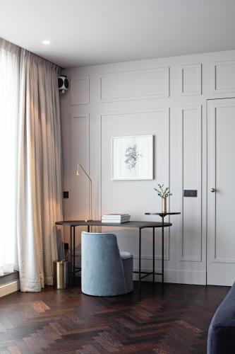 a living room with a desk and a chair at Pillows Grand Boutique Hotel Reylof Ghent in Ghent