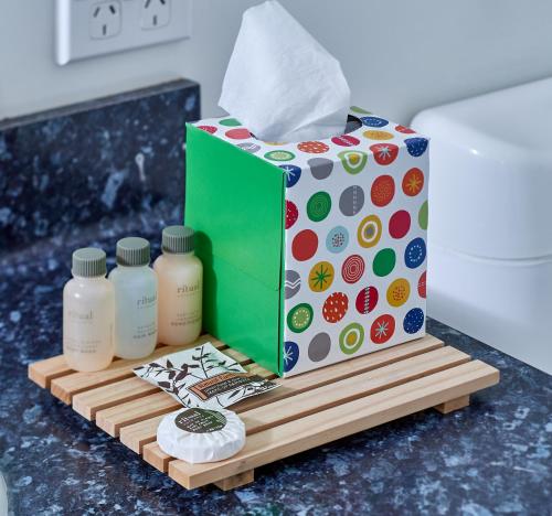 a gift box and three bottles of milk on a table at Livingston Motel in Whakatane