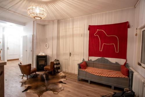 a bedroom with a bed with a horse on the wall at The Mangevie in Furudal
